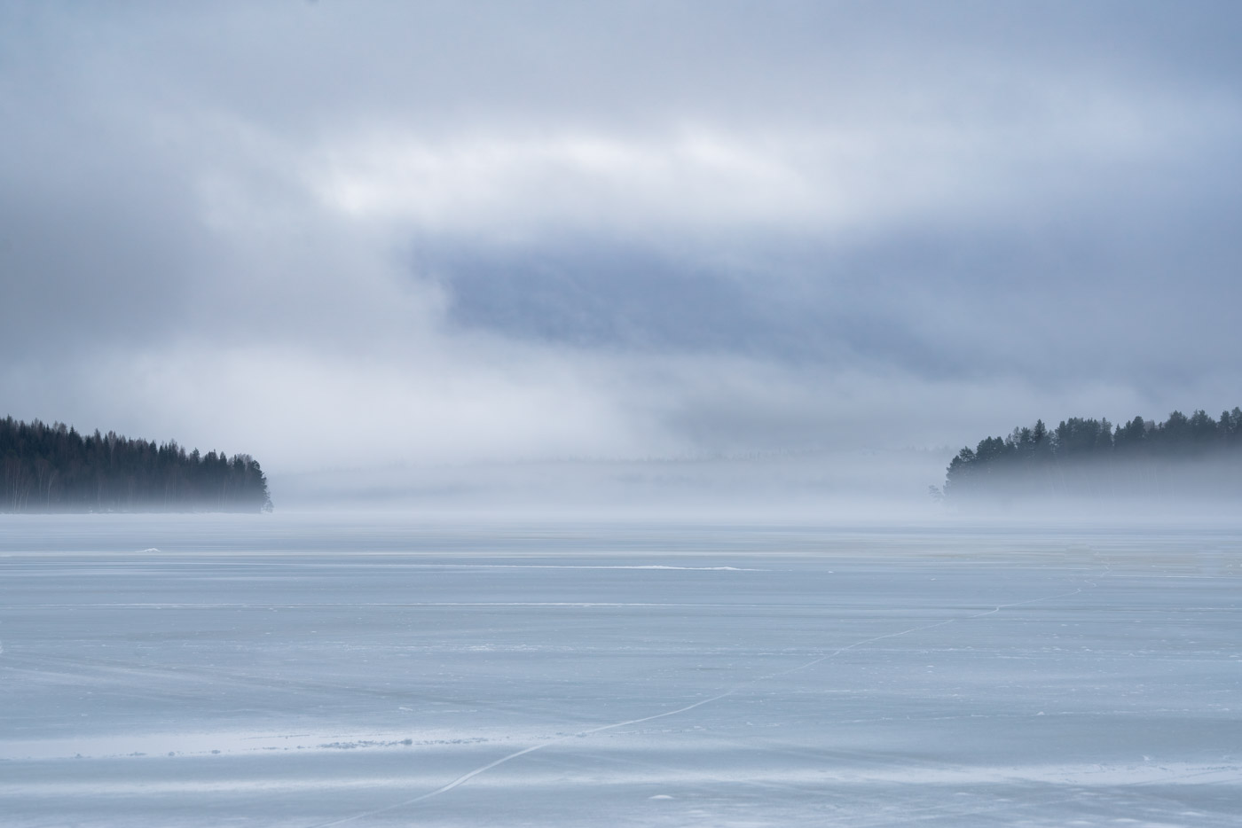 A misty cold morning by a forest lake in Sweden